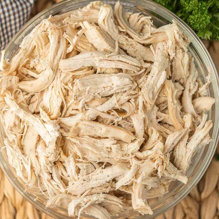 shredded chicken in a glass bowl