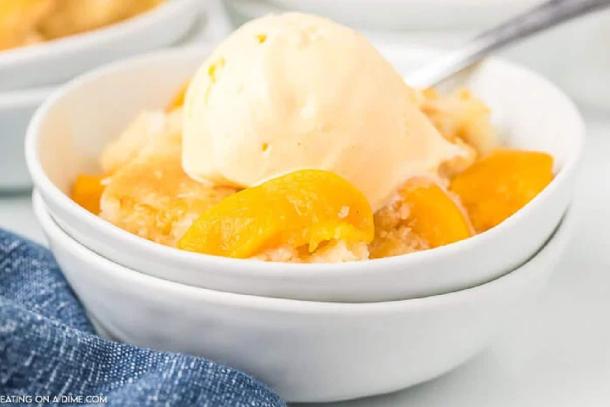Come home to the best Crock pot peach cobbler recipe all ready to enjoy. The slow cooker does all of the work and we love it with ice cream. Come home to the best Crock pot peach cobbler recipe all ready to enjoy. The slow cooker does all of the work and we love it with ice cream.Â