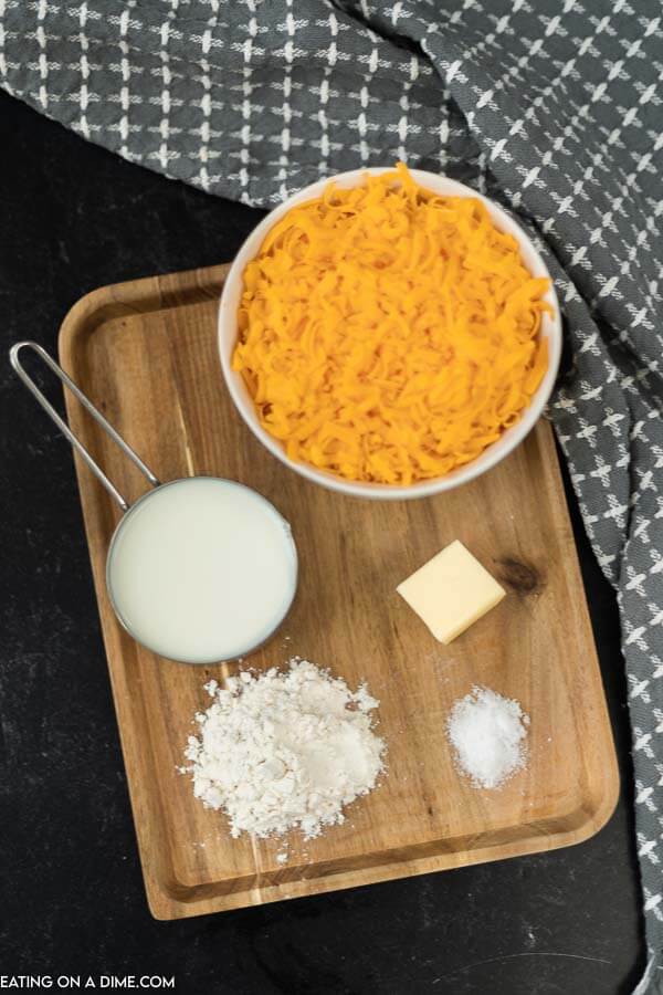 picture of ingredients: shredded cheese, milk, flour, butter.