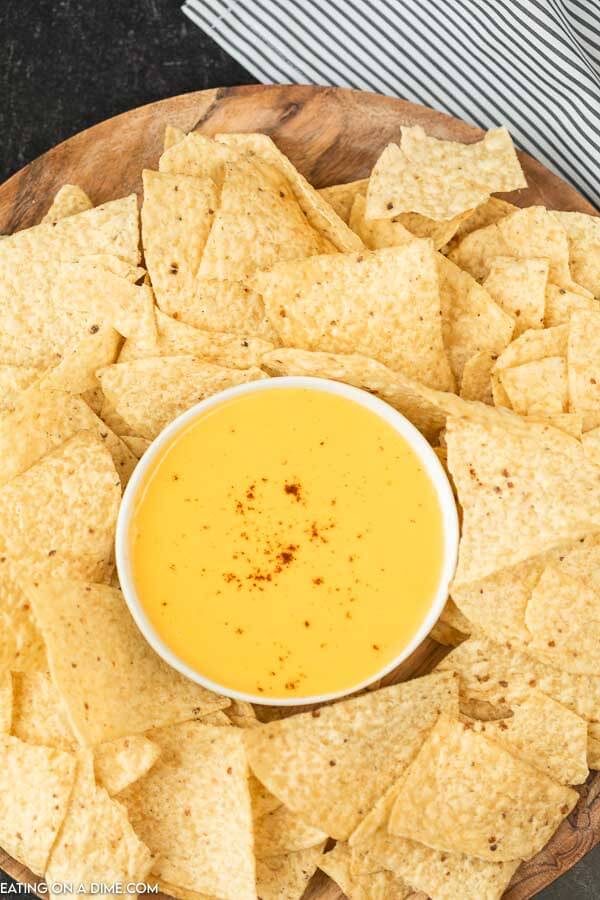 picture of tortilla chips and nacho cheese dip in a platter