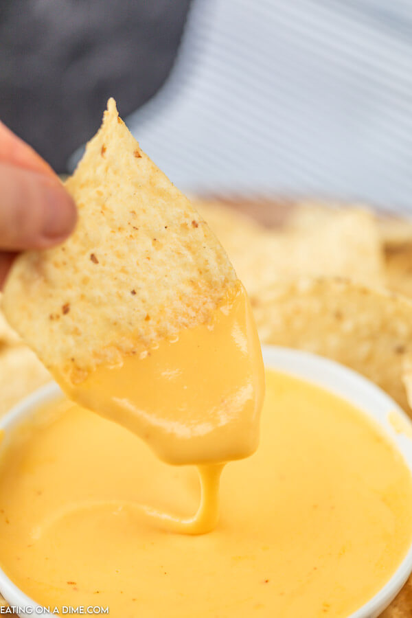 picture of tortilla chip dipped in cheese