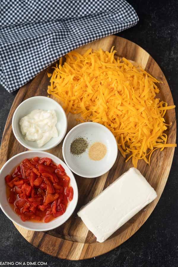 ingredients for pimento cheese - mayonnaise, seasoning, cream cheese, shredded cheese, pimento peppers
