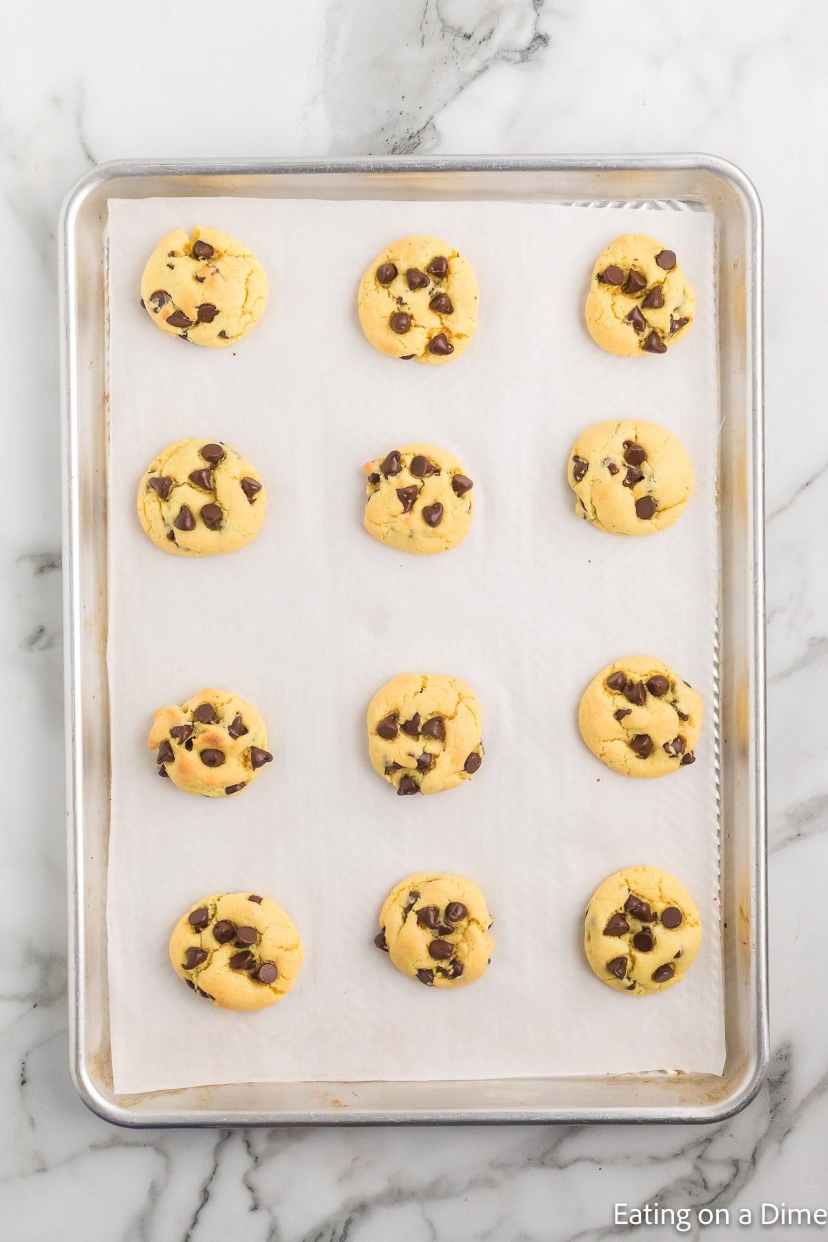 Baked chocolate chip cookies on a baking sheet