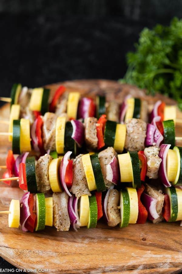 photo of chicken and vegetable skewers on wooden tray