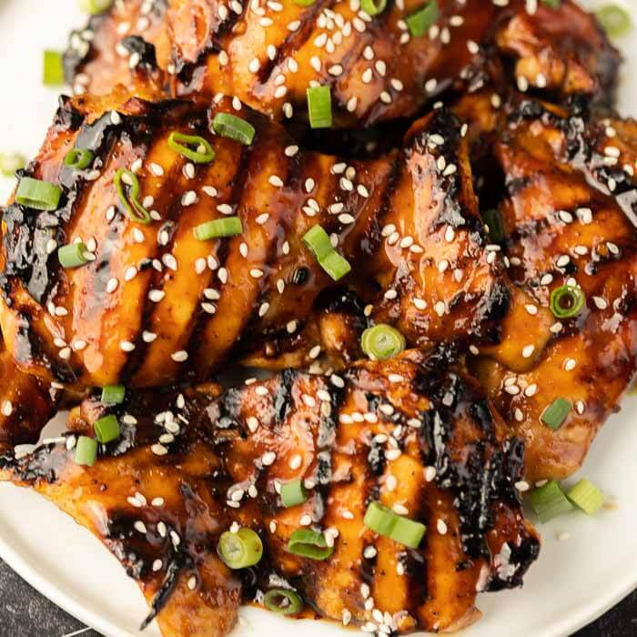 closeup photo of grilled teriyaki chicken on plate. 