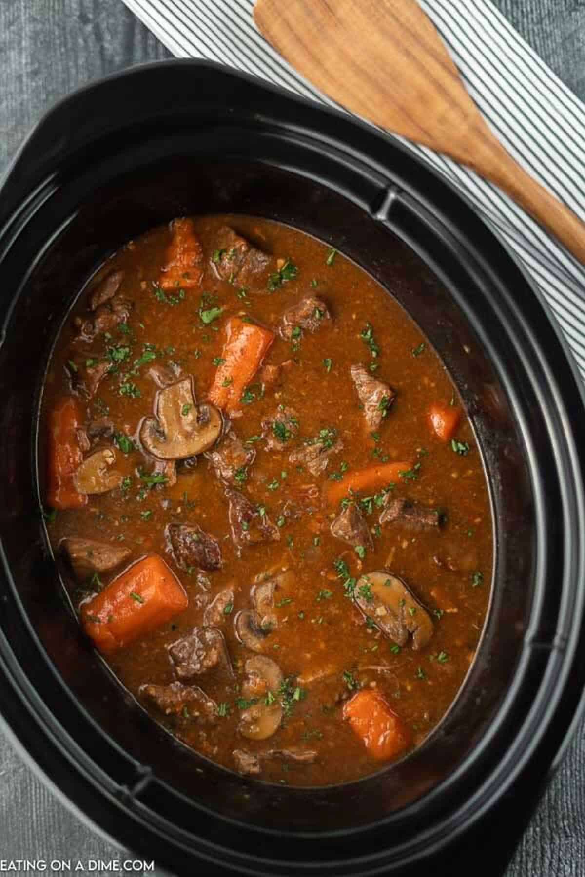 Slow cooker beef bourguignon sounds fancy and tastes amazing but the recipe is so easy to make. The beef is tender and the broth is savory. Slow cooker beef bourguignon