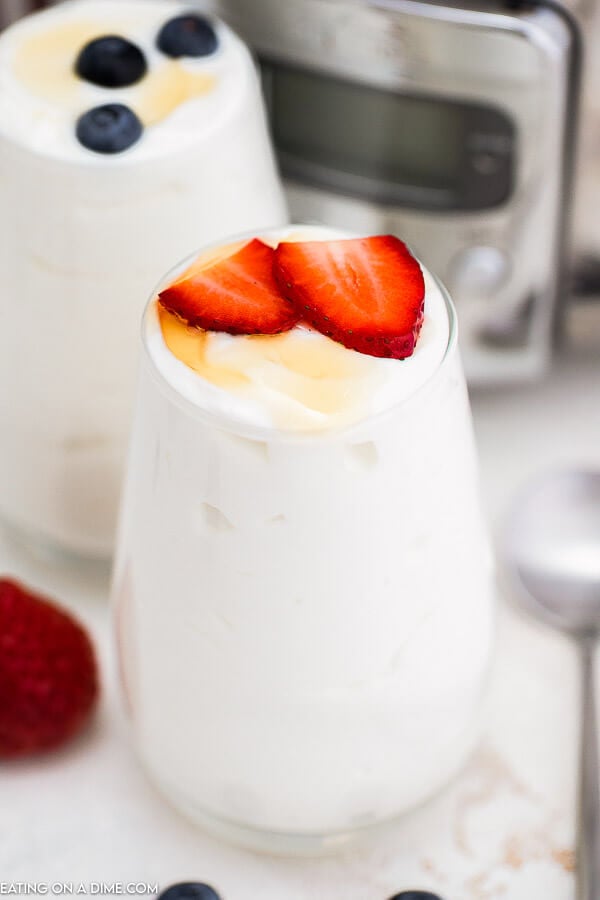 Yogurt in a glass topped with strawberries