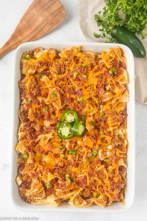 If you love cheesy jalapeño poppers, you are going to love Jalapeno popper chicken casserole recipe. Use precooked chicken and have dinner in 30 minutes. Close up image of a 9x13 pan of jalapeno popper chicken casserole.