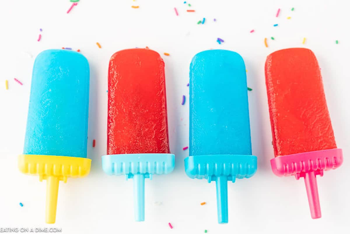 different flavors of jello popsicles on a white board 