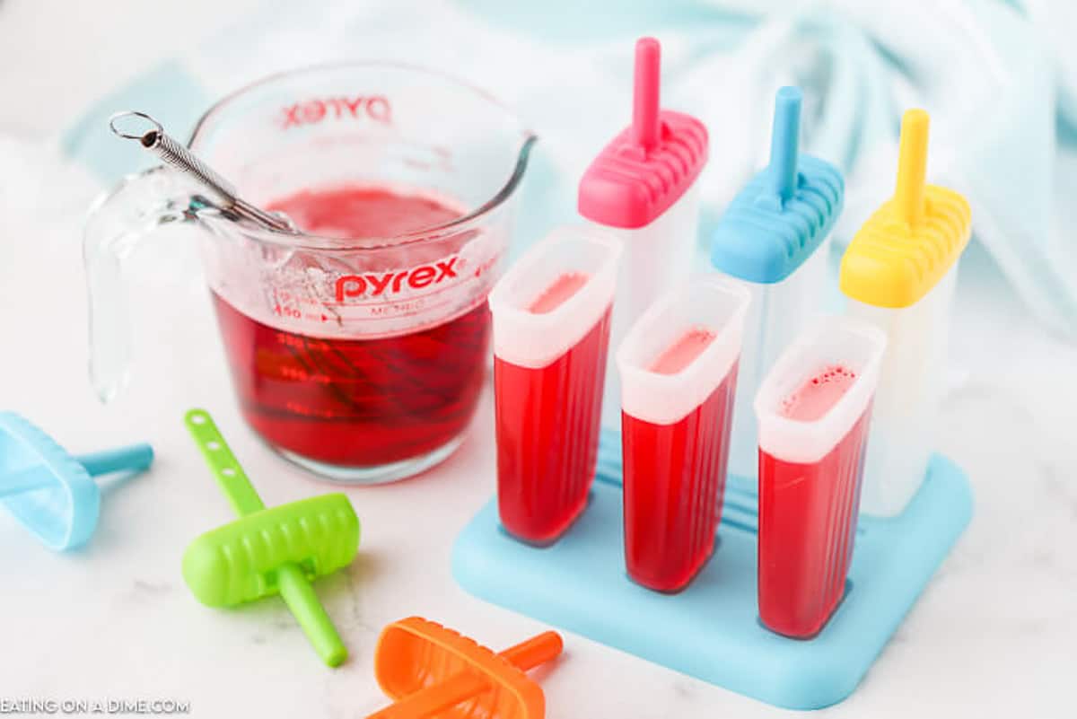 pouring liquid in the popsicle molds