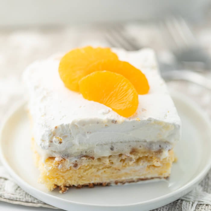 photo of mandarin orange cake slice on plate