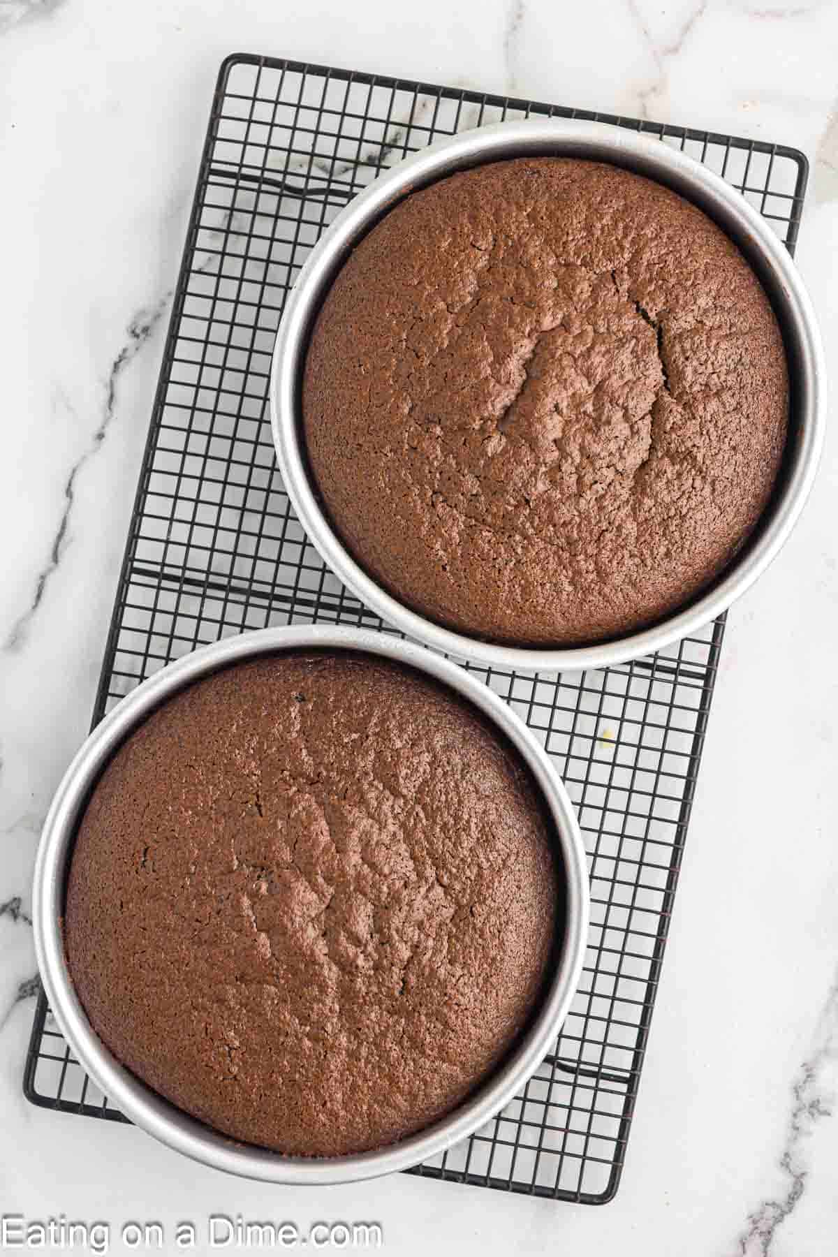 Baked round cake pans on a cooling rack