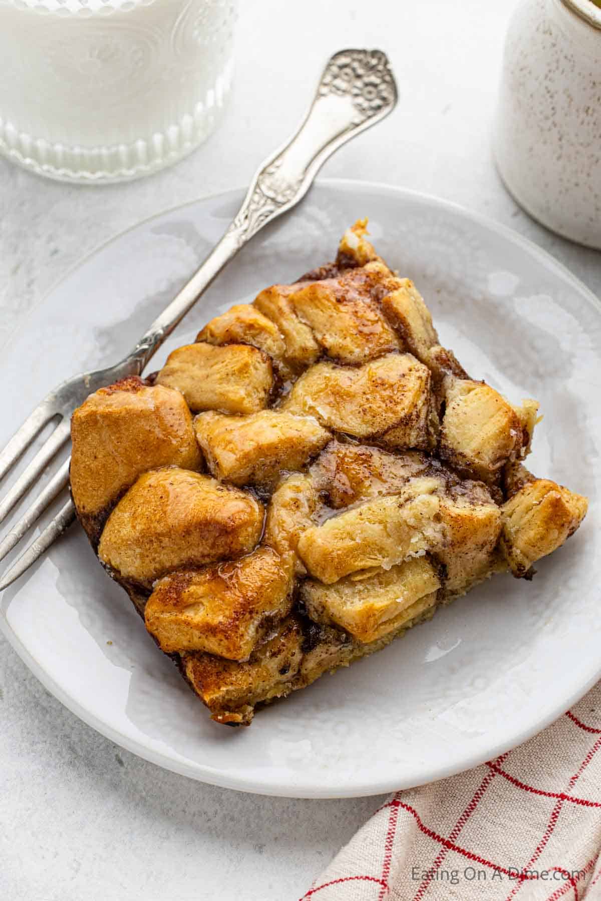 A serving of cinnamon roll french toast casserole on a plate