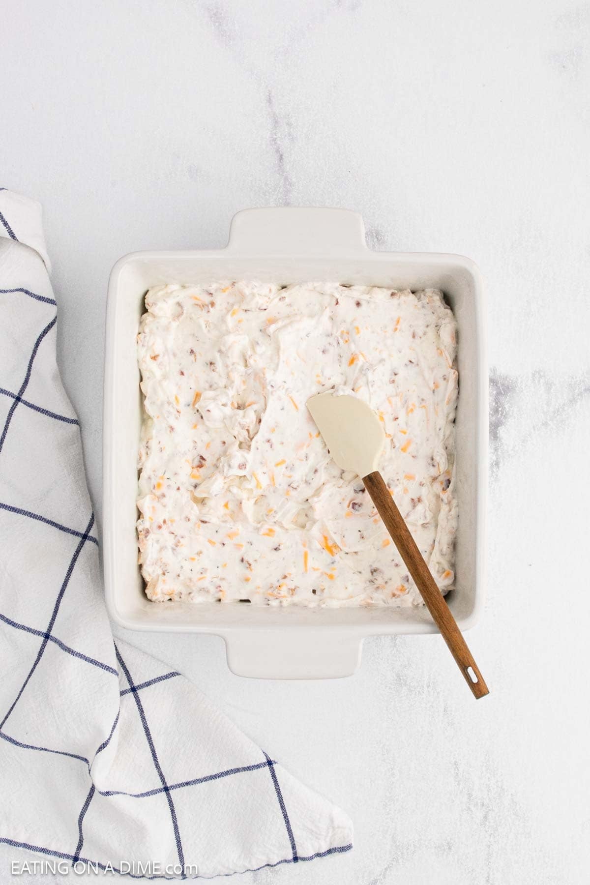 A white dish with Crack Dip served in it.