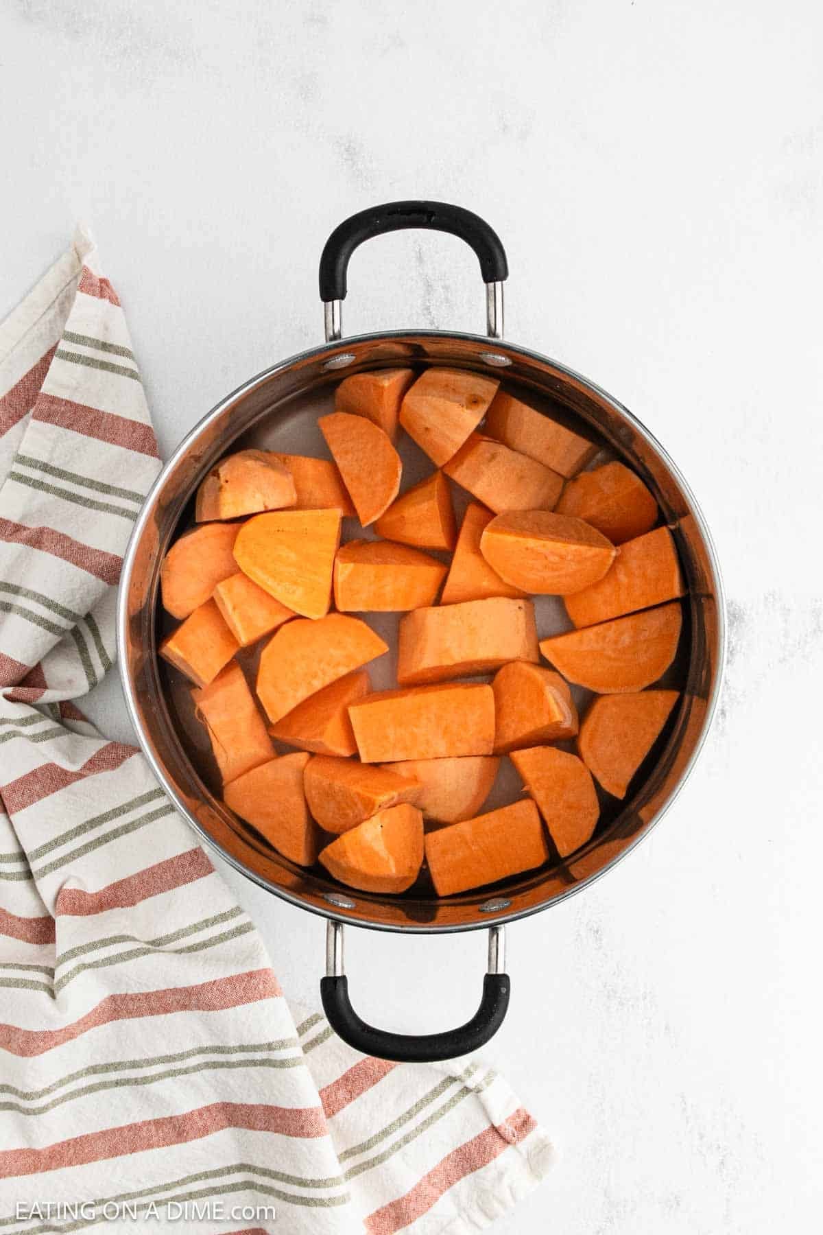 Diced sweet potatoes in a large pot of water.