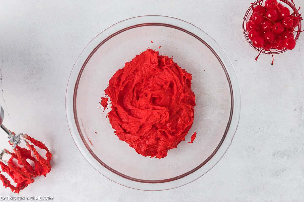 Adding the red food coloring to the frosting