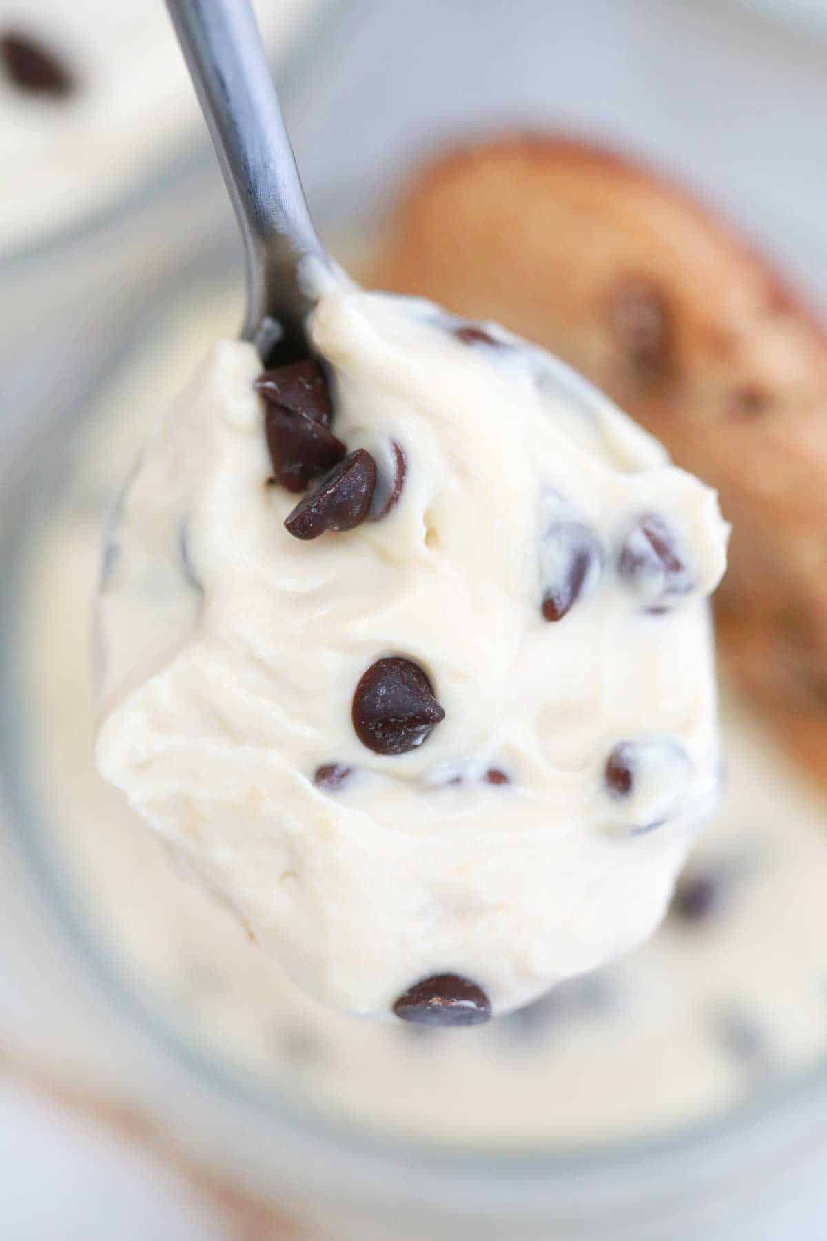 Close up image of a spoonful of chocolate chip cheesecake.