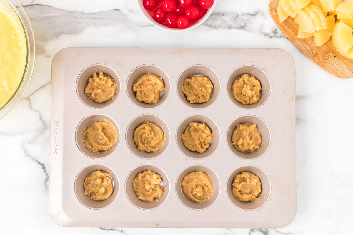 Placing the brown sugar mixture into the cupcake tin