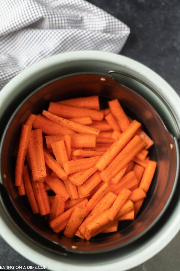Placing the carrots in the air fryer