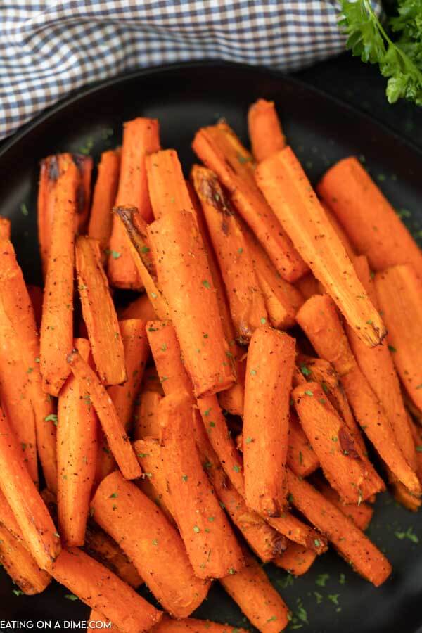 Placing cooked carrots on a serving platter