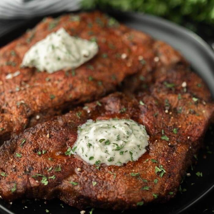 steak on a plate with garlic butter