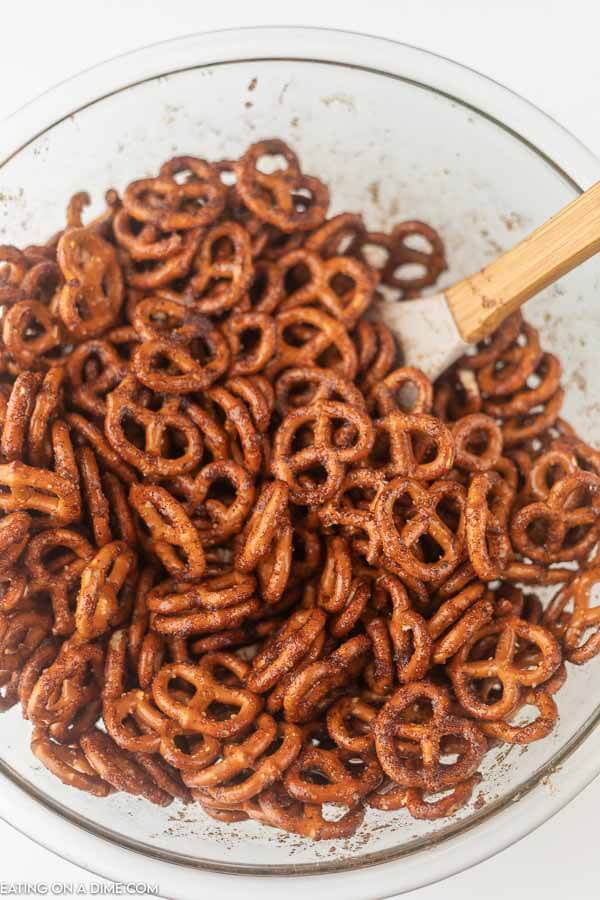 Picture of pretzels being coated in cinnamon mixture.