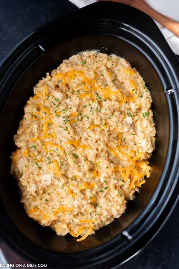 Overview of this crock pot chicken and rice recipe in a black crock pot. 