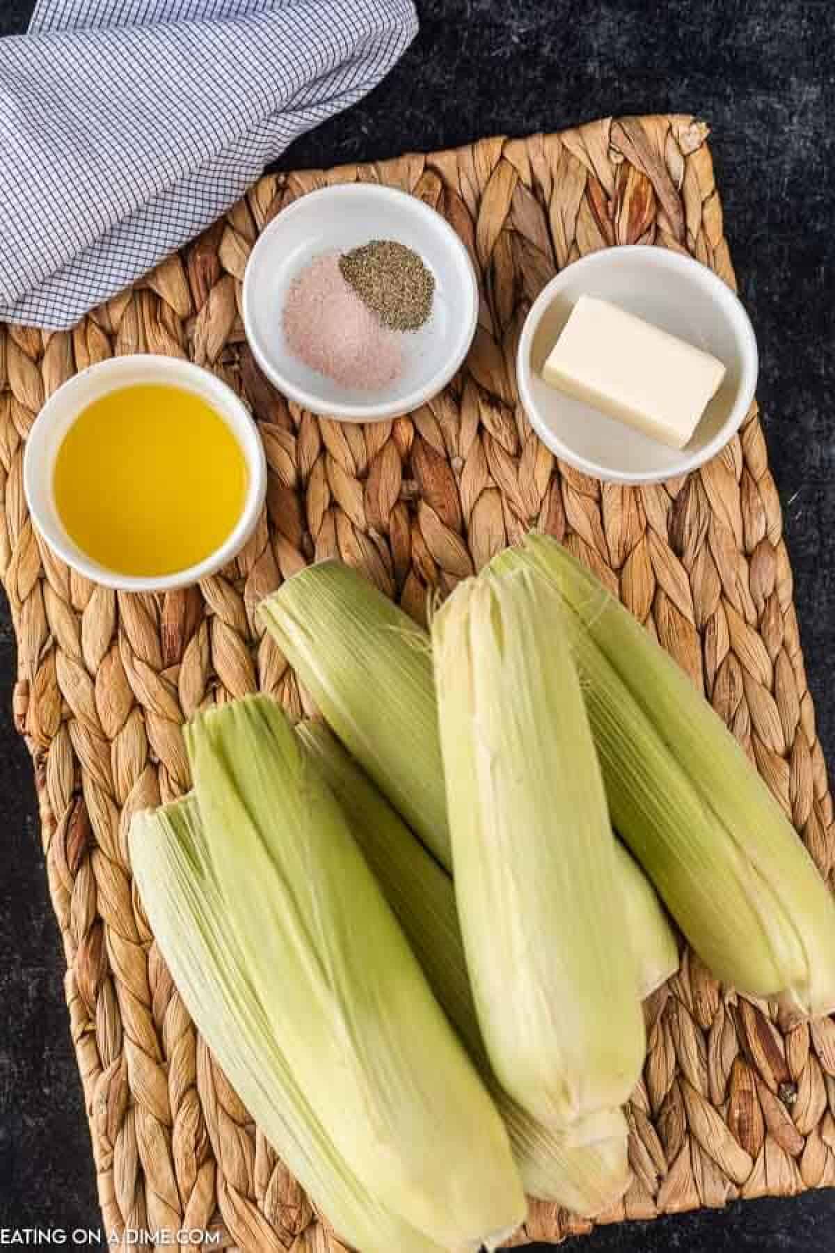 picture of ingredients: oil, butter, seasoning, corn on the cob