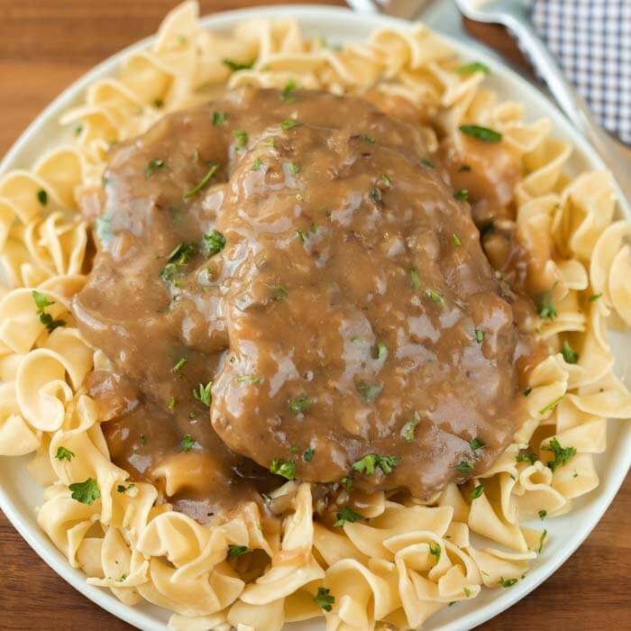 Plate of egg noodles with cube steak and gravy