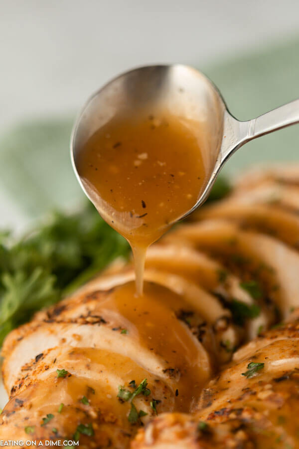 sliced turkey with gravy being drizzled on it