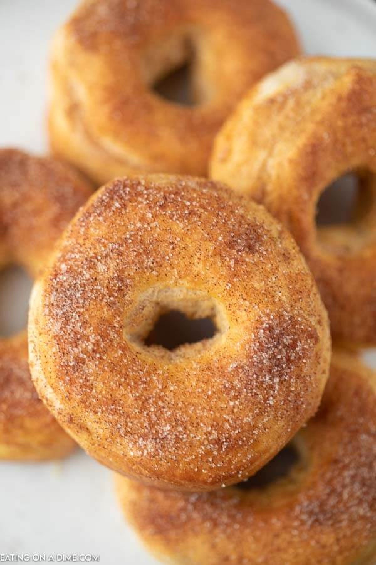 Close up image of donuts on a white plate.