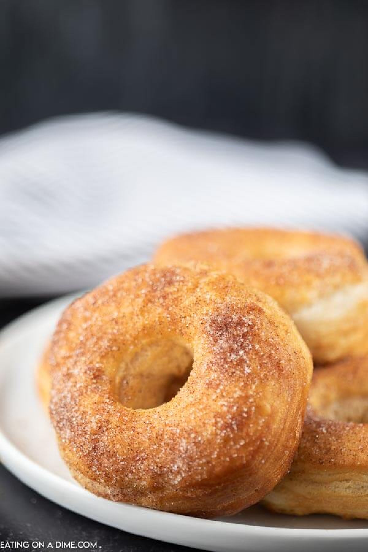 Close up image of donuts on a white plate. 