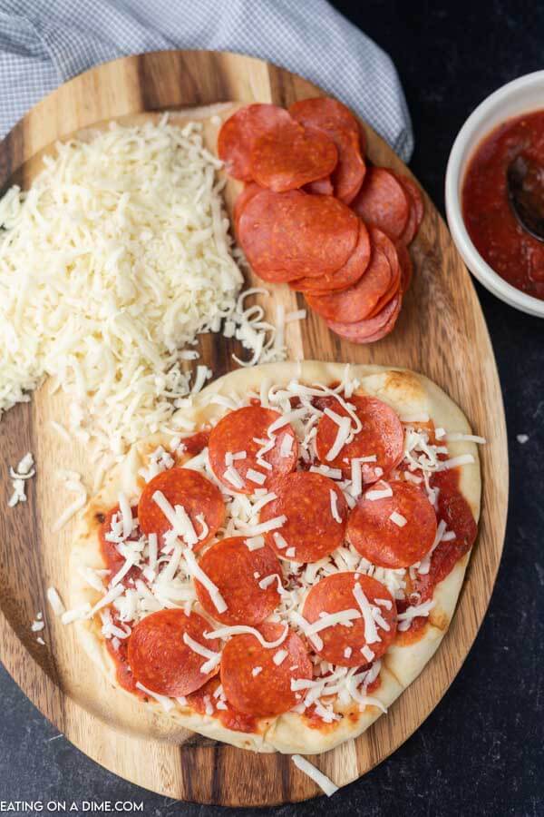 Close up image of ingredients for pepperoni pizza. 