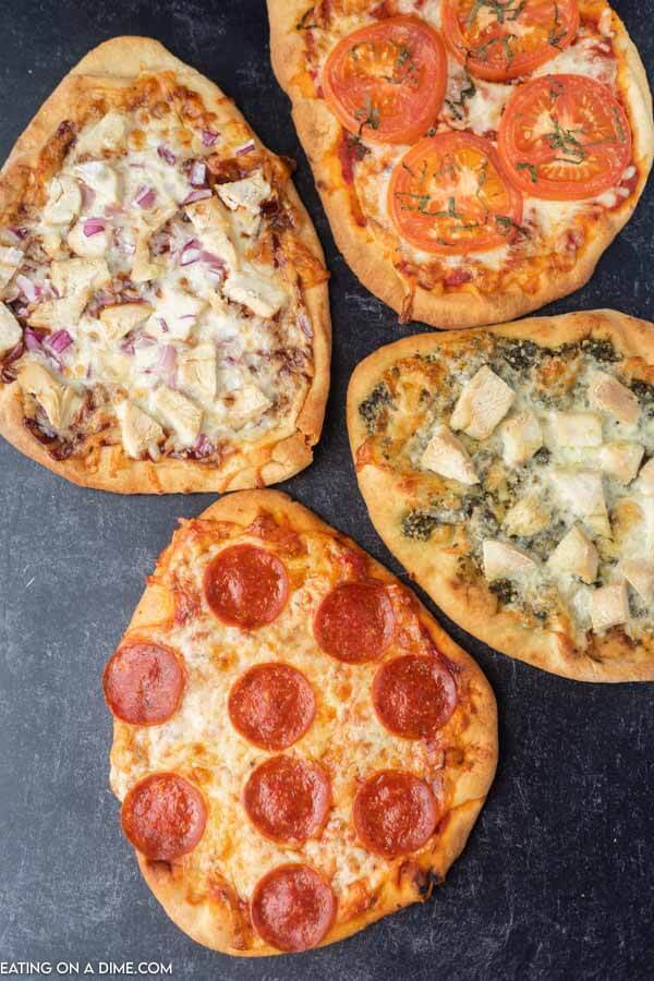 Close up image of 4 flatbread pizzas. 