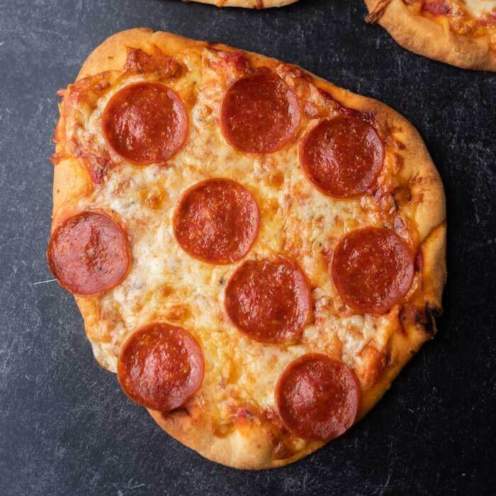 Close up image of a flatbread pepperoni pizza. 
