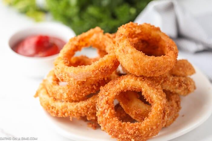 plate of onion rings with ketchup