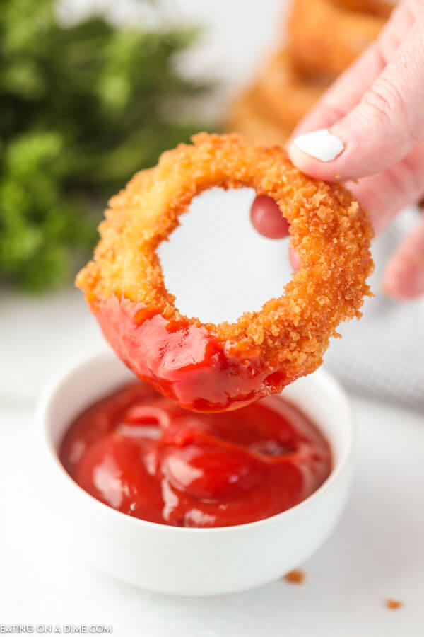 onion ring dipped in ketchup