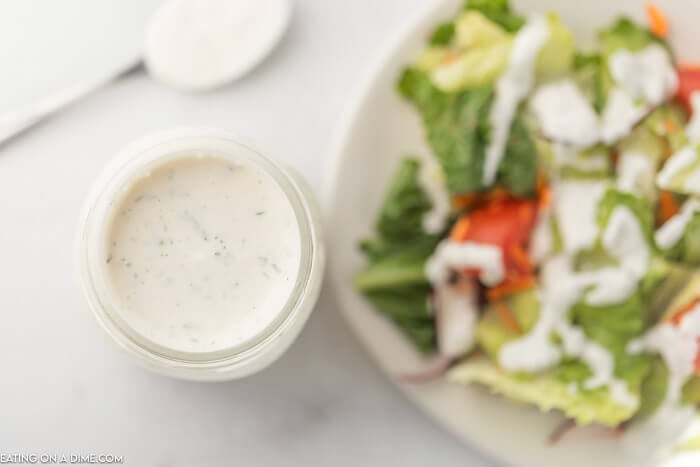 ranch dressing in a jar with a salad