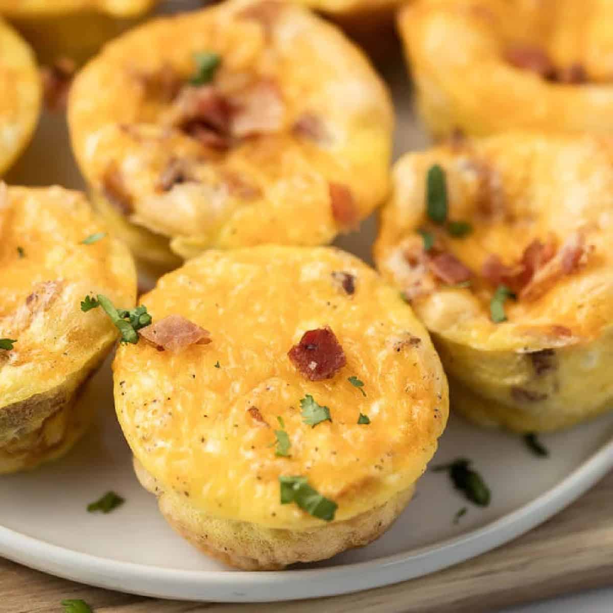 Egg muffins stacked on a plate.