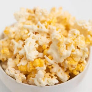 A bowl of white chocolate popcorn.