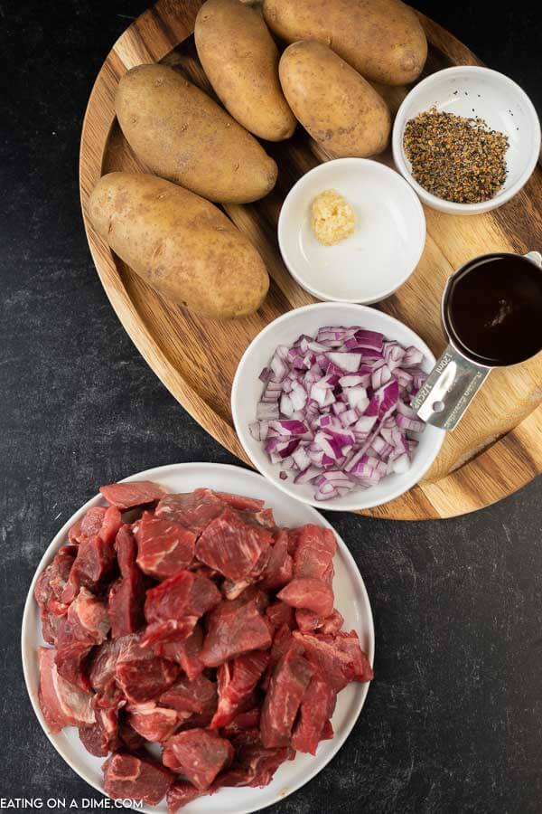 Ingredients needed - stew meat, red onion, potatoes, minced garlic, steak seasoning, steak sauce, beef broth, corn starch, bay leaves