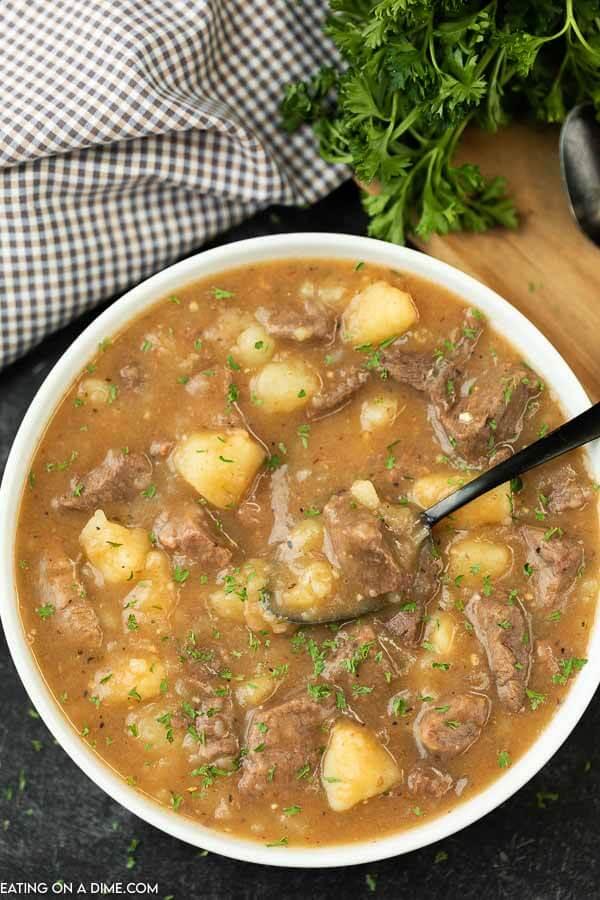 Beef and Potato Stew in a white bowl with a black spoon