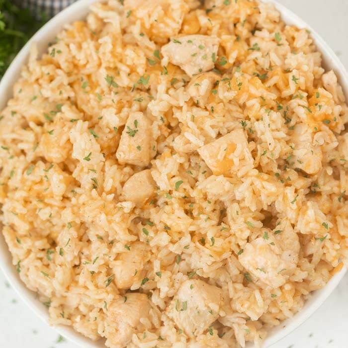 Close up of the chicken and rice in a large bowl topped with parsley.  