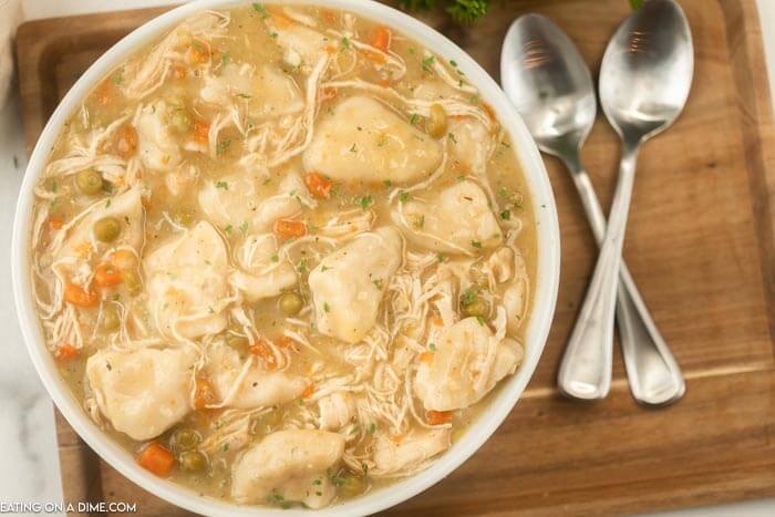 bowl of chicken and dumplings on a tray