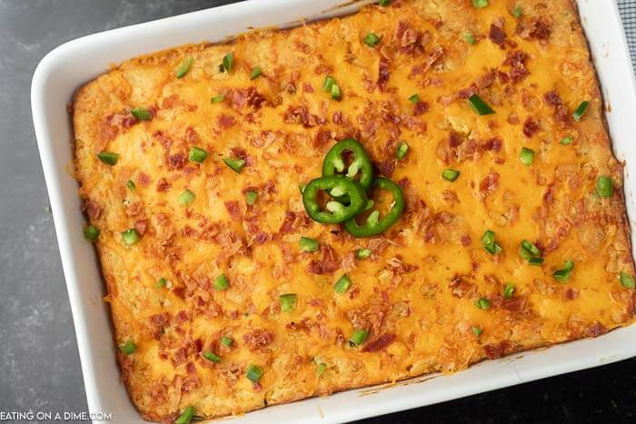 Close up of this Jalapeño Popper Corn Casserole in a white casserole pan.  