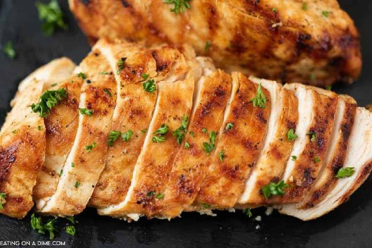 Sliced grilled chicken topped with fresh herbs