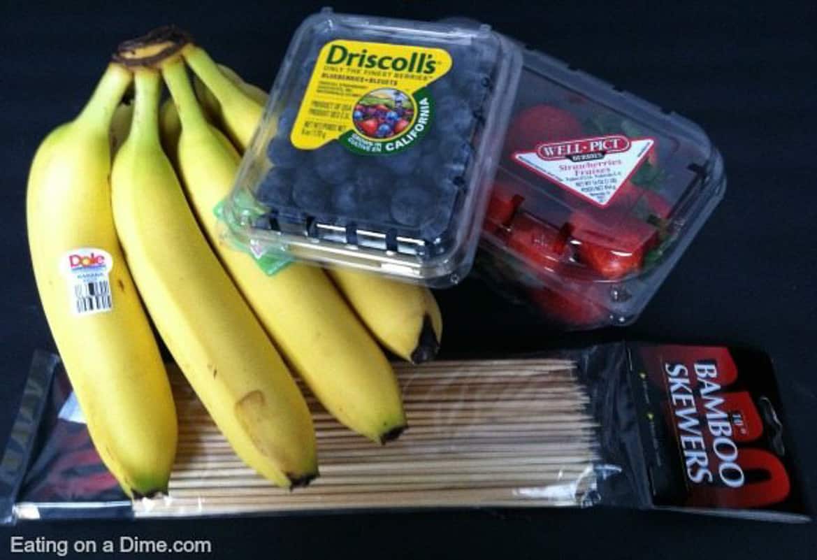 Ingredients to make 4th of July Fruit Kabobs: Bananas, blueberries, strawberries and wooden skewers 