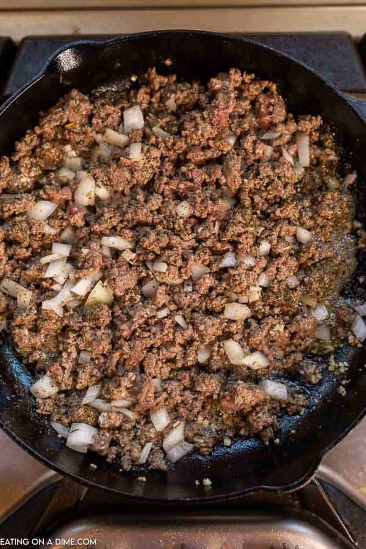 The brown beef browned in a large cast iron pan with onions and garlic.  Then the mixture is seasoned with salt, pepper and Italian seasoning.  