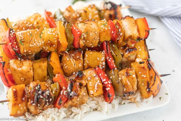 closeup photo of chicken kabobs on a plate