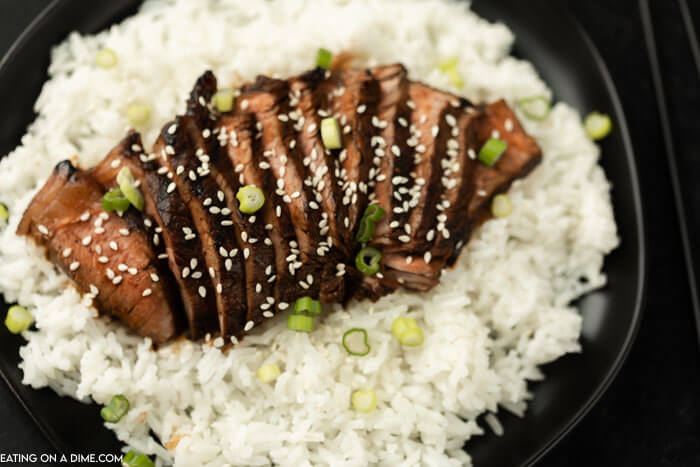steak on a plate of rice